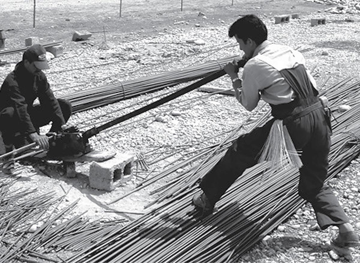 Iraqi subcontractors cut rebar for a health care clinic under construction outside of Erbil, Iraq, 20 June 2005. The clinic will handle primary health care requirements for a suburban neighborhood outside of Erbil. The U.S. Army Corps of Engineers oversees the project and works directly with Iraqi workers and contractor companies.